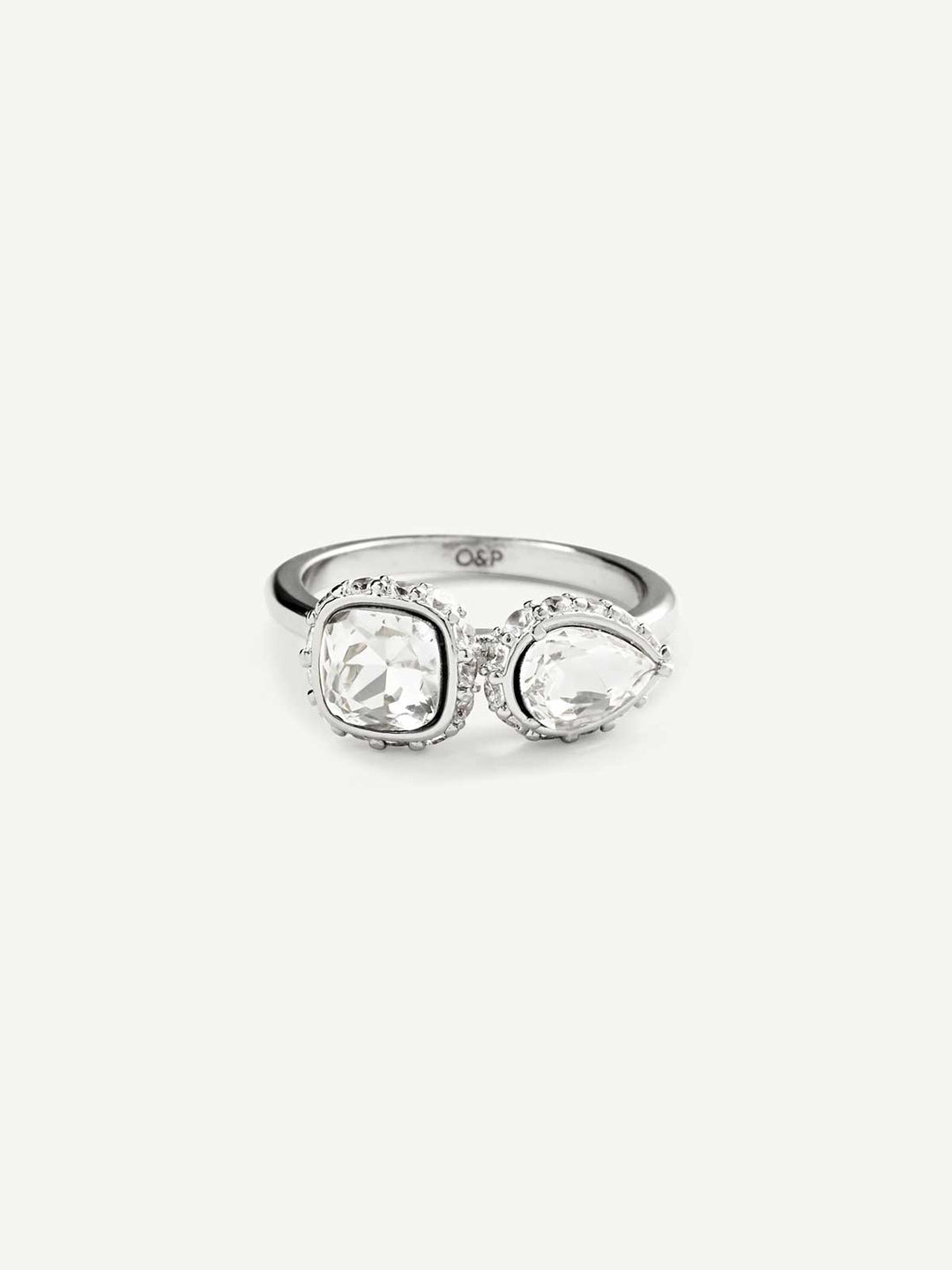 Silver ring with two clear gemstones on a white background