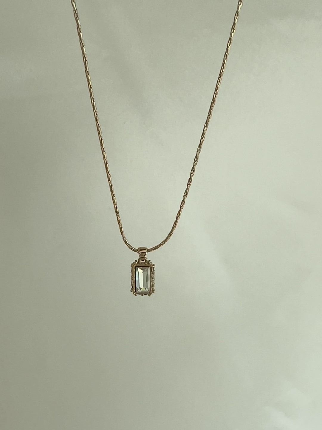 Gold necklace with a rectangular pendant 